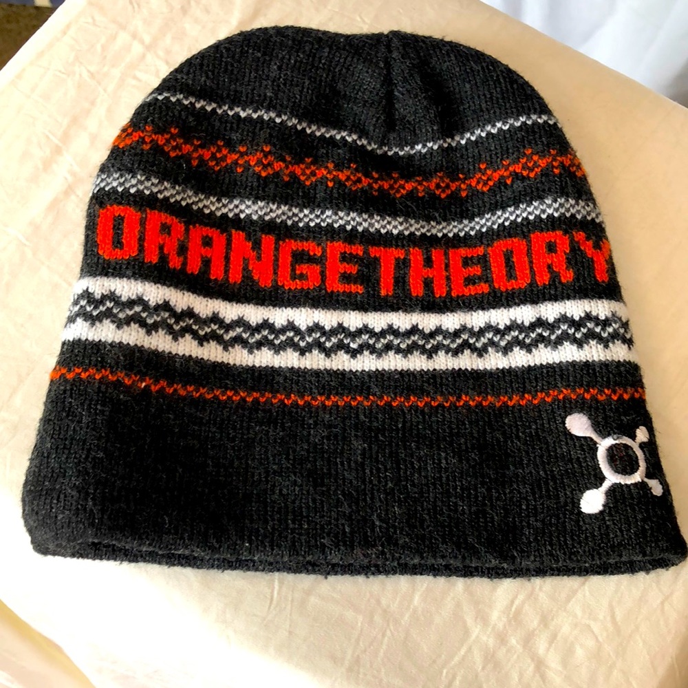 ORANGE THEORY acrylic gray, orange, and white skull type hat.